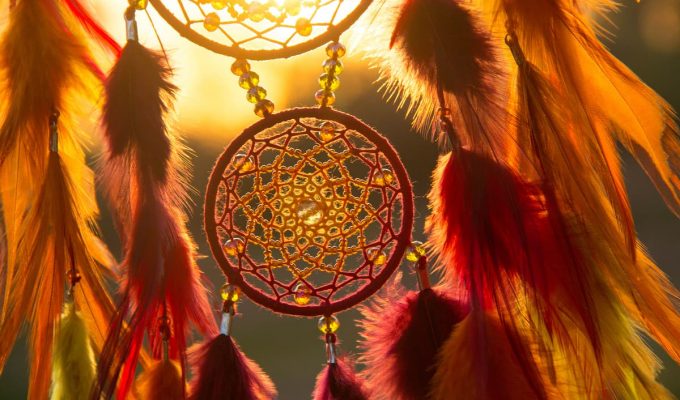 Atrapasueños con plumas de colores iluminado por la luz del sol, símbolo de protección y buenas energías en septiembre 2025.
