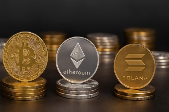 Monedas digitales con símbolos de Bitcoin, Ethereum, Cardano, Tether y Solana en fondo dorado.
