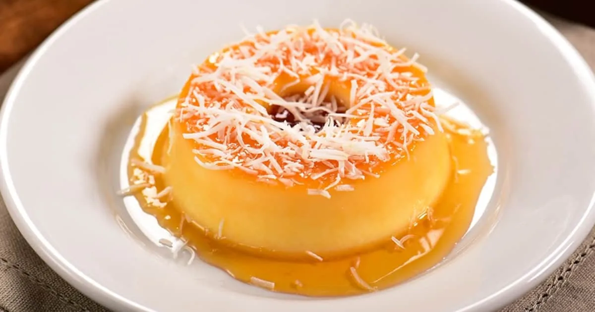 Flan de coco con caramelo y coco rallado por encima en un plato blanco
