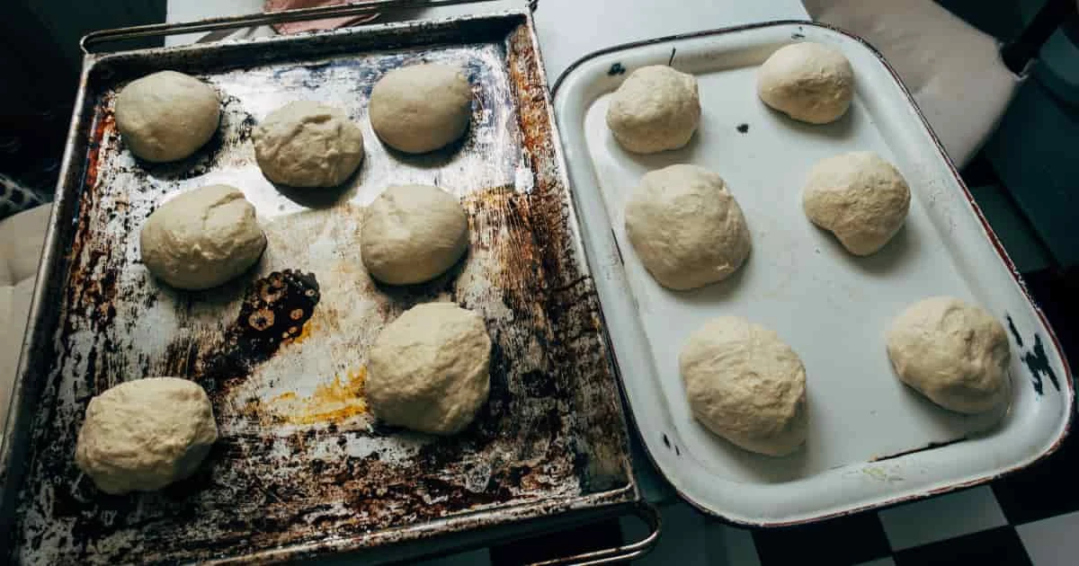 Bollitos de masa de pan de queso sobre bandeja forrada antes de entrar al horno