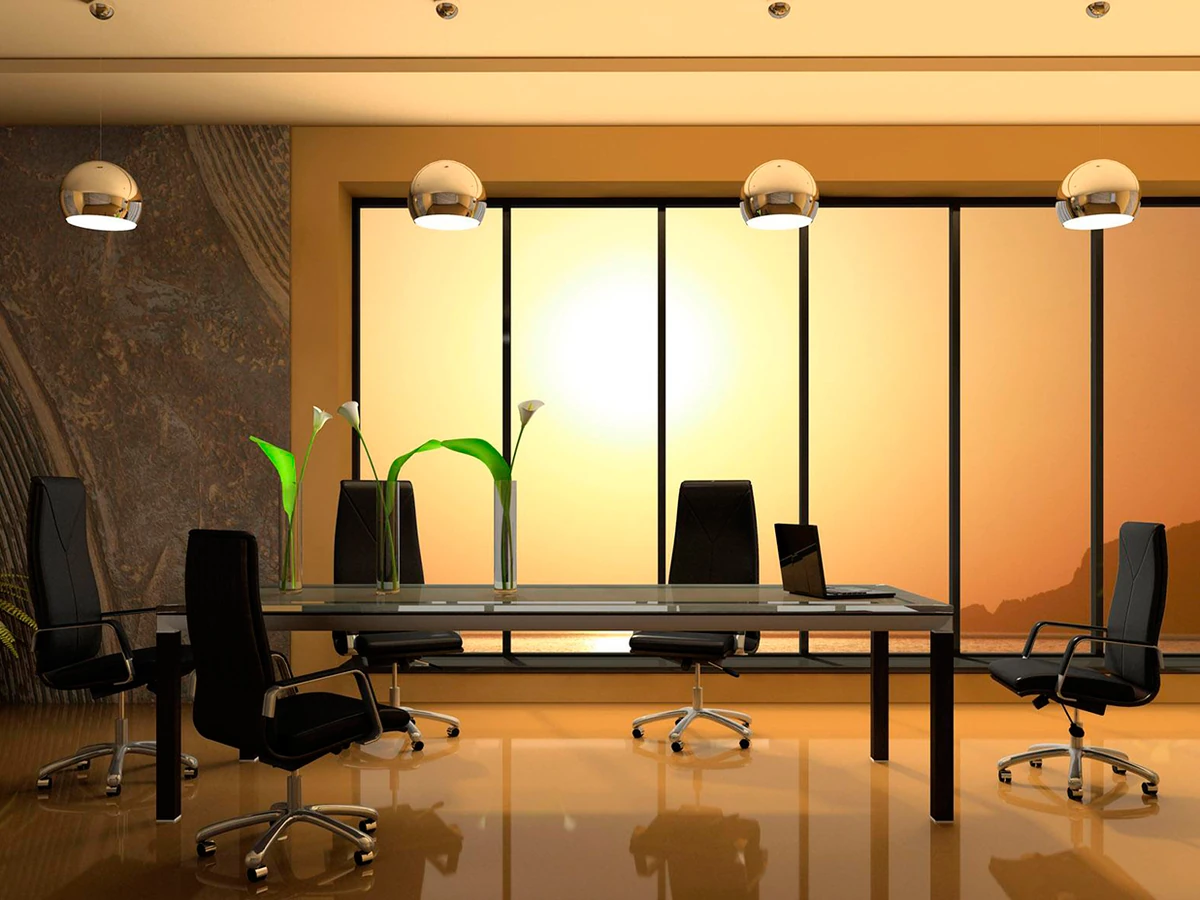 Lujosa sala de juntas ejecutiva con una mesa de cristal y vista al mar durante el atardecer